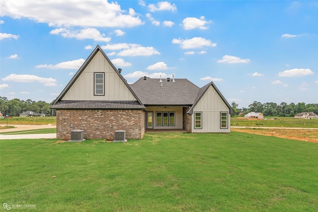 916 Aaron Ln, Benton, LA 71006 - rear view of house featuring a shingled roof, a lawn, board and batten siding, and brick siding