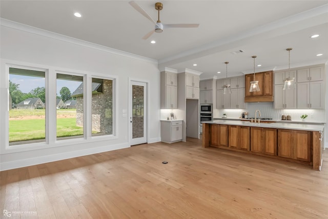 916 Aaron Ln, Benton, LA 71006 - kitchen featuring ceiling fan, crown molding, light wood-style flooring, recessed lighting, and a spacious island