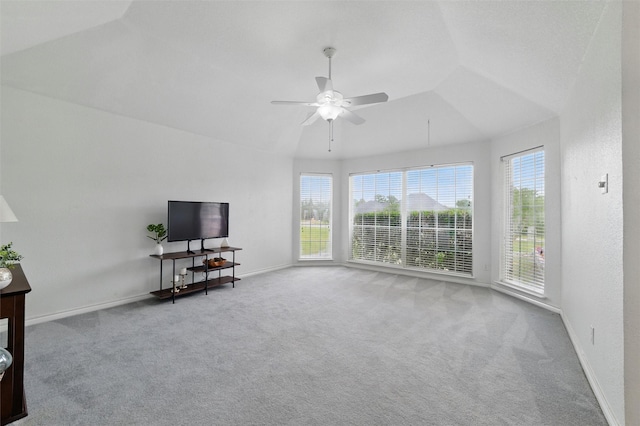 living area featuring carpet flooring, ceiling fan, baseboards, and lofted ceiling