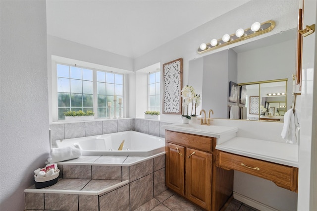 bathroom with a whirlpool tub, tile patterned flooring, and vanity