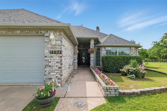 view of front of property with fence, a shingled roof, a front lawn, a garage, and a chimney