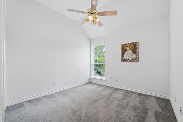 carpeted spare room with baseboards, ceiling fan, and lofted ceiling