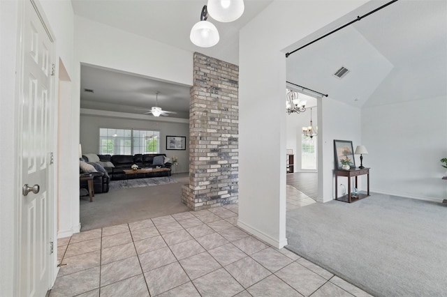 hallway featuring high vaulted ceiling, light colored carpet, light tile patterned floors, and visible vents