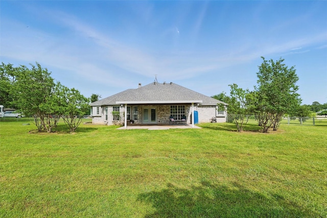 rear view of house featuring fence, a patio, and a yard