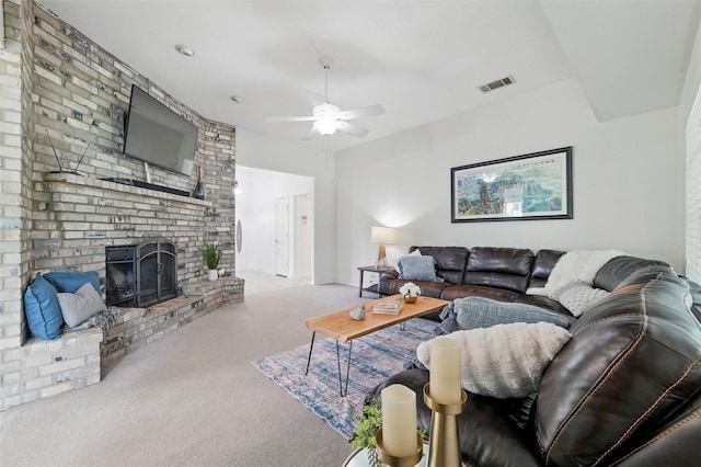 living area with carpet flooring, ceiling fan, visible vents, and a brick fireplace