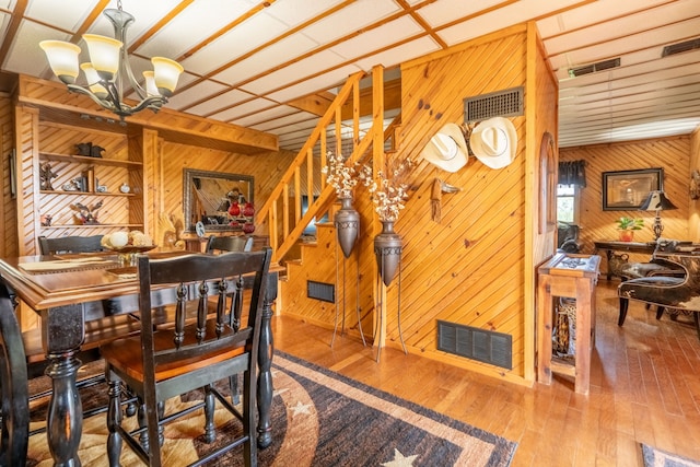 12282 Fm 1392, Terrell, TX 75160 - dining room featuring wood walls, a notable chandelier, and visible vents