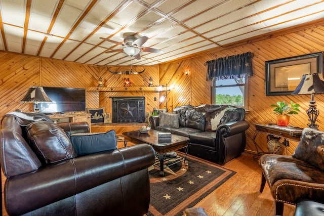 12282 Fm 1392, Terrell, TX 75160 - living room with wooden walls, hardwood / wood-style flooring, and a ceiling fan