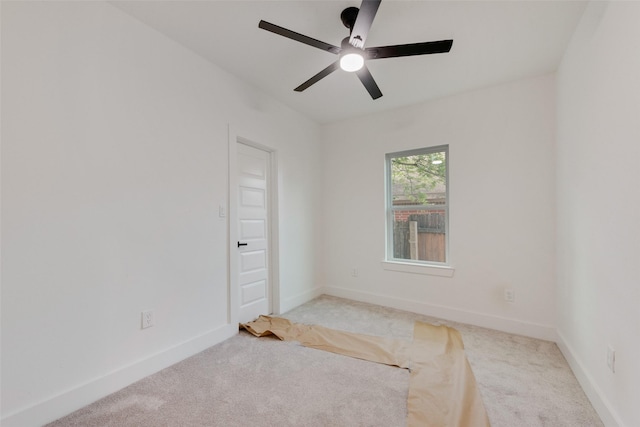 empty room with baseboards, a ceiling fan, and carpet