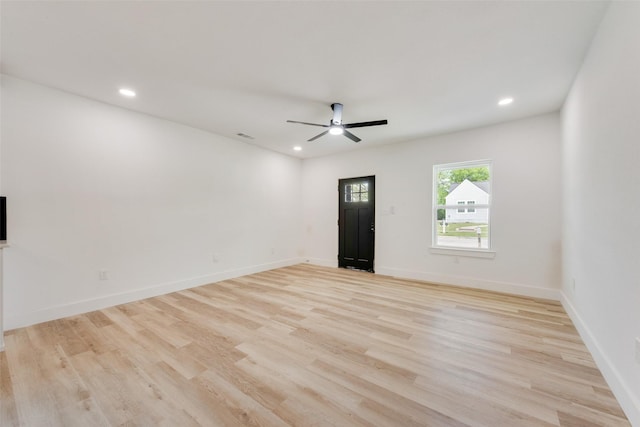 spare room with light wood-type flooring, a ceiling fan, and recessed lighting