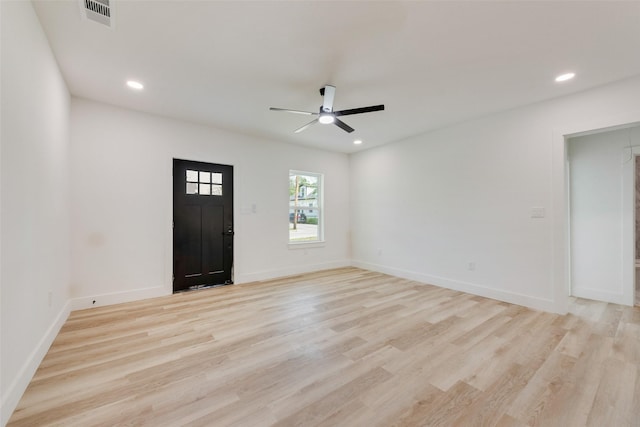 foyer with visible vents, baseboards, light wood-style flooring, and ceiling fan
