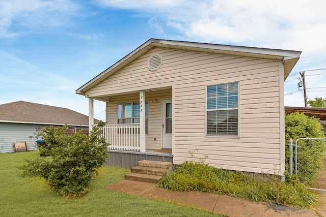 bungalow-style house with covered porch and a front yard