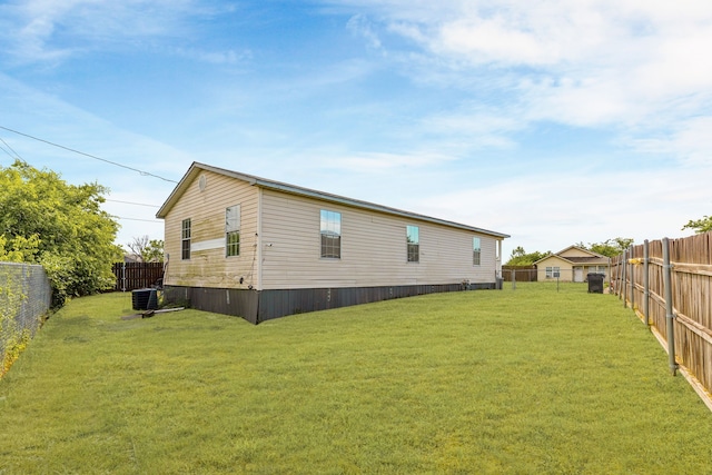 exterior space with a lawn, central AC, and a fenced backyard