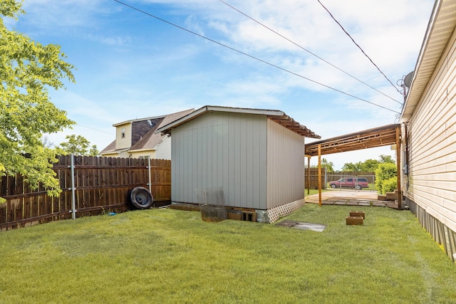view of yard featuring a fenced backyard, an outbuilding, and a shed