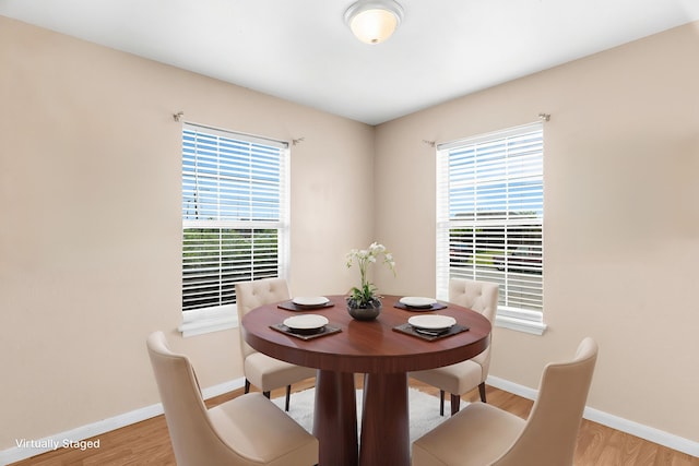 dining area with wood finished floors and baseboards