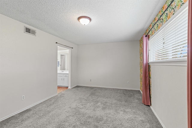 3206 Knights Haven Ln, Garland, TX 75044 - unfurnished room featuring a textured ceiling, light carpet, and baseboards