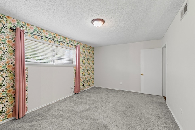 3206 Knights Haven Ln, Garland, TX 75044 - empty room featuring carpet flooring, wallpapered walls, a textured ceiling, and baseboards