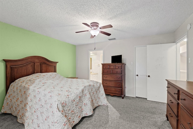 3206 Knights Haven Ln, Garland, TX 75044 - bedroom with light carpet, a textured ceiling, ceiling fan, and ensuite bath