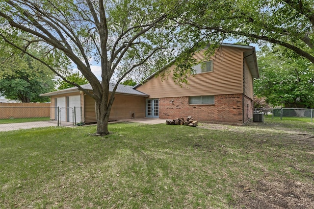 3206 Knights Haven Ln, Garland, TX 75044 - view of front of house with french doors, central AC unit, a garage, driveway, and a gate