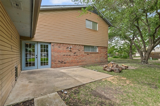 3206 Knights Haven Ln, Garland, TX 75044 - back of property with brick siding, a patio, french doors, and fence