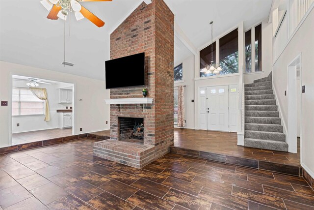 3206 Knights Haven Ln, Garland, TX 75044 - unfurnished living room featuring high vaulted ceiling, ceiling fan, stairway, and wood finished floors