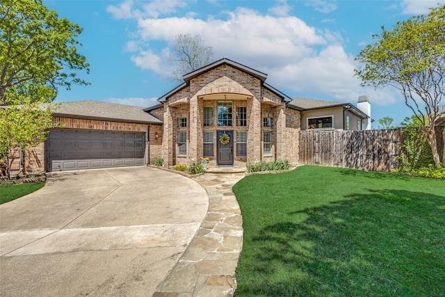 view of front of property featuring brick siding, fence, a front lawn, concrete driveway, and an attached garage