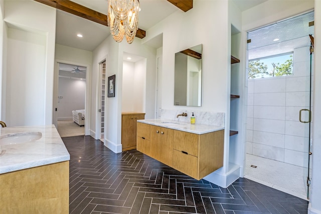 full bathroom featuring a chandelier, a stall shower, two vanities, and a sink