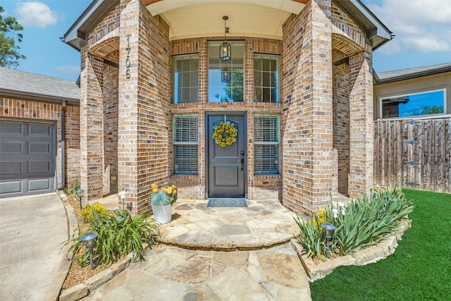 doorway to property with fence and brick siding