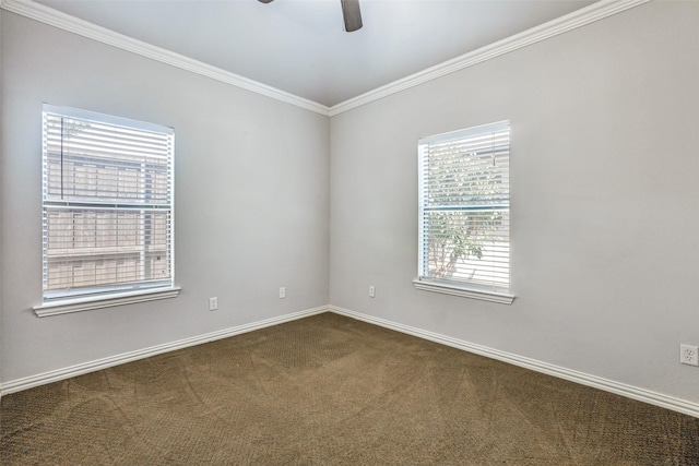 empty room featuring dark carpet, ceiling fan, ornamental molding, and baseboards
