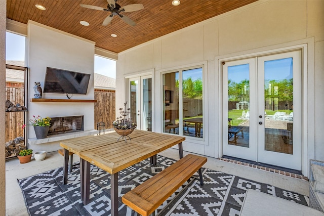 sunroom featuring french doors and a healthy amount of sunlight