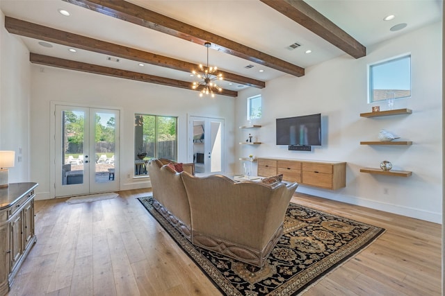 living area with beamed ceiling, light wood-style floors, visible vents, baseboards, and french doors