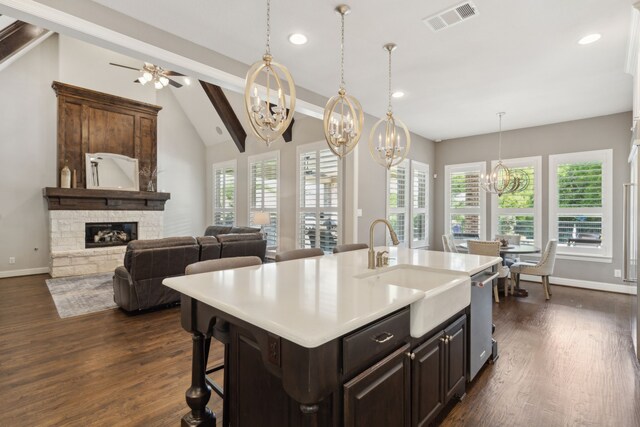 kitchen featuring a healthy amount of sunlight, a sink, visible vents, and a fireplace