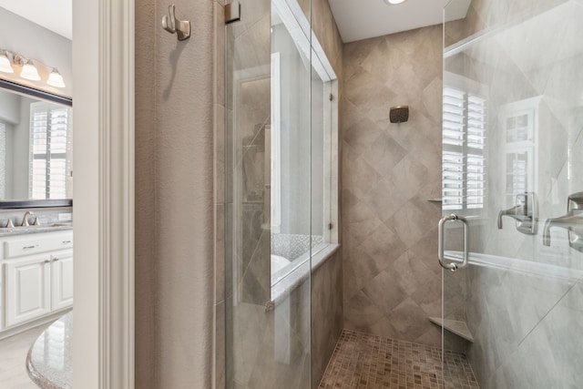 full bathroom featuring vanity and a stall shower