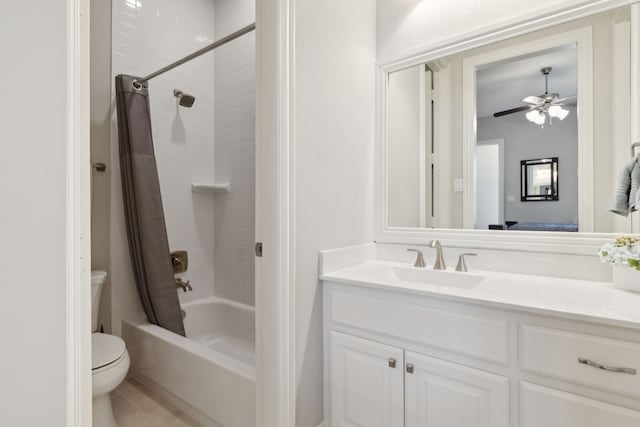 ensuite bathroom with tile patterned floors, vanity, shower / bathtub combination with curtain, ceiling fan, and toilet
