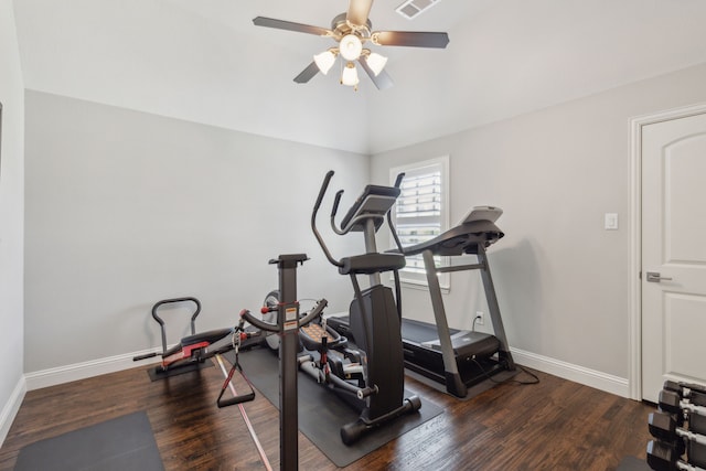 workout area featuring lofted ceiling, wood finished floors, visible vents, baseboards, and ceiling fan