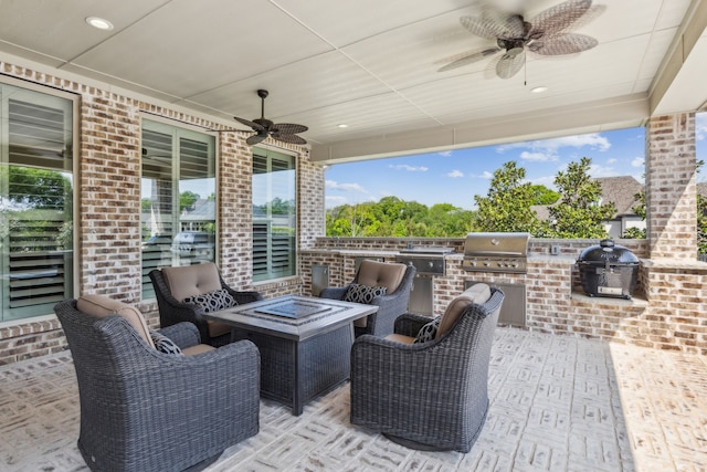 view of patio featuring a grill, an outdoor fire pit, ceiling fan, and area for grilling