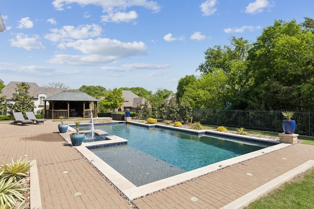 view of swimming pool featuring a fenced in pool, a gazebo, fence, a wooden deck, and a jacuzzi