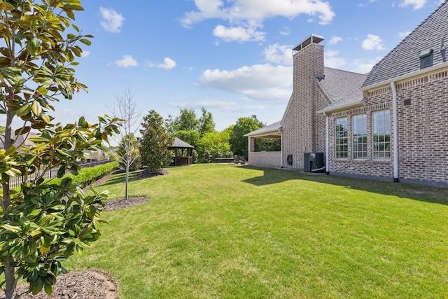 view of yard with fence, a gazebo, and central AC
