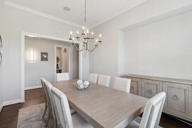 dining area featuring crown molding, arched walkways, dark wood finished floors, baseboards, and a notable chandelier