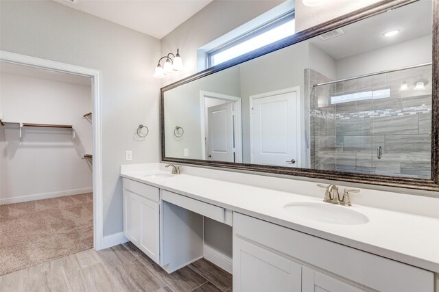 1624 Sweetwater Way, Celina, TX 75009 - full bathroom featuring double vanity, a stall shower, and a spacious closet