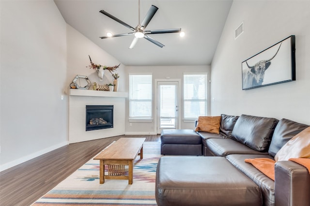 4737 Tanglewood Dr, Haltom City, TX 76137 - living room featuring a glass covered fireplace, baseboards, a ceiling fan, visible vents, and wood finished floors