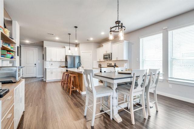 4737 Tanglewood Dr, Haltom City, TX 76137 - dining space with wood finished floors, baseboards, a toaster, and recessed lighting