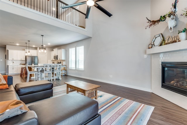 4737 Tanglewood Dr, Haltom City, TX 76137 - living room with a ceiling fan, a fireplace, baseboards, and dark wood-style floors