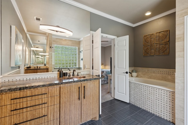 bathroom featuring a garden tub, vanity, ensuite bath, ornamental molding, and visible vents
