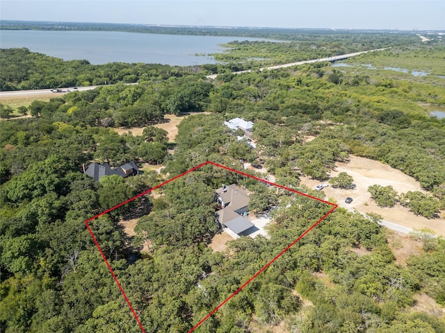 aerial view with a water view and a forest view