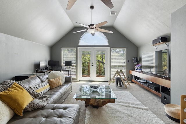 carpeted living room with french doors, visible vents, ceiling fan, and lofted ceiling
