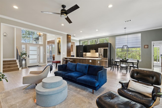 living room with recessed lighting, plenty of natural light, and crown molding