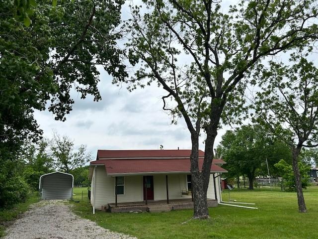 239 Ranch Rd, Joshua, TX 76058 - view of front facade with a carport, a front lawn, a porch, and gravel driveway