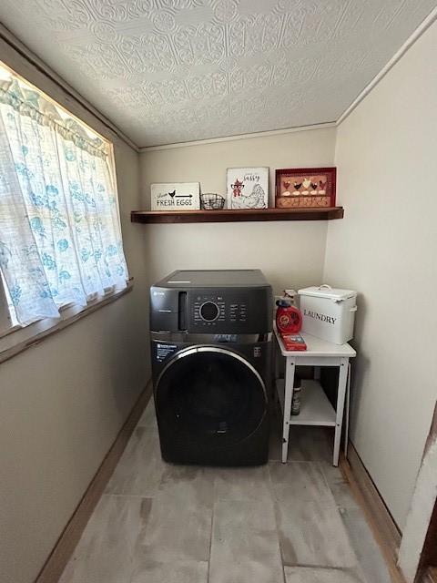 239 Ranch Rd, Joshua, TX 76058 - washroom with washer / clothes dryer, a textured ceiling, and baseboards