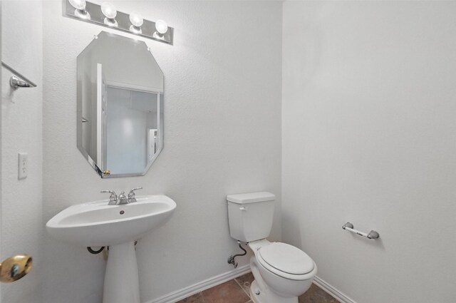 full bathroom with tile patterned flooring, vanity, baseboards, and a stall shower