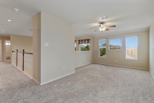 spare room featuring visible vents, baseboards, a ceiling fan, recessed lighting, and light carpet